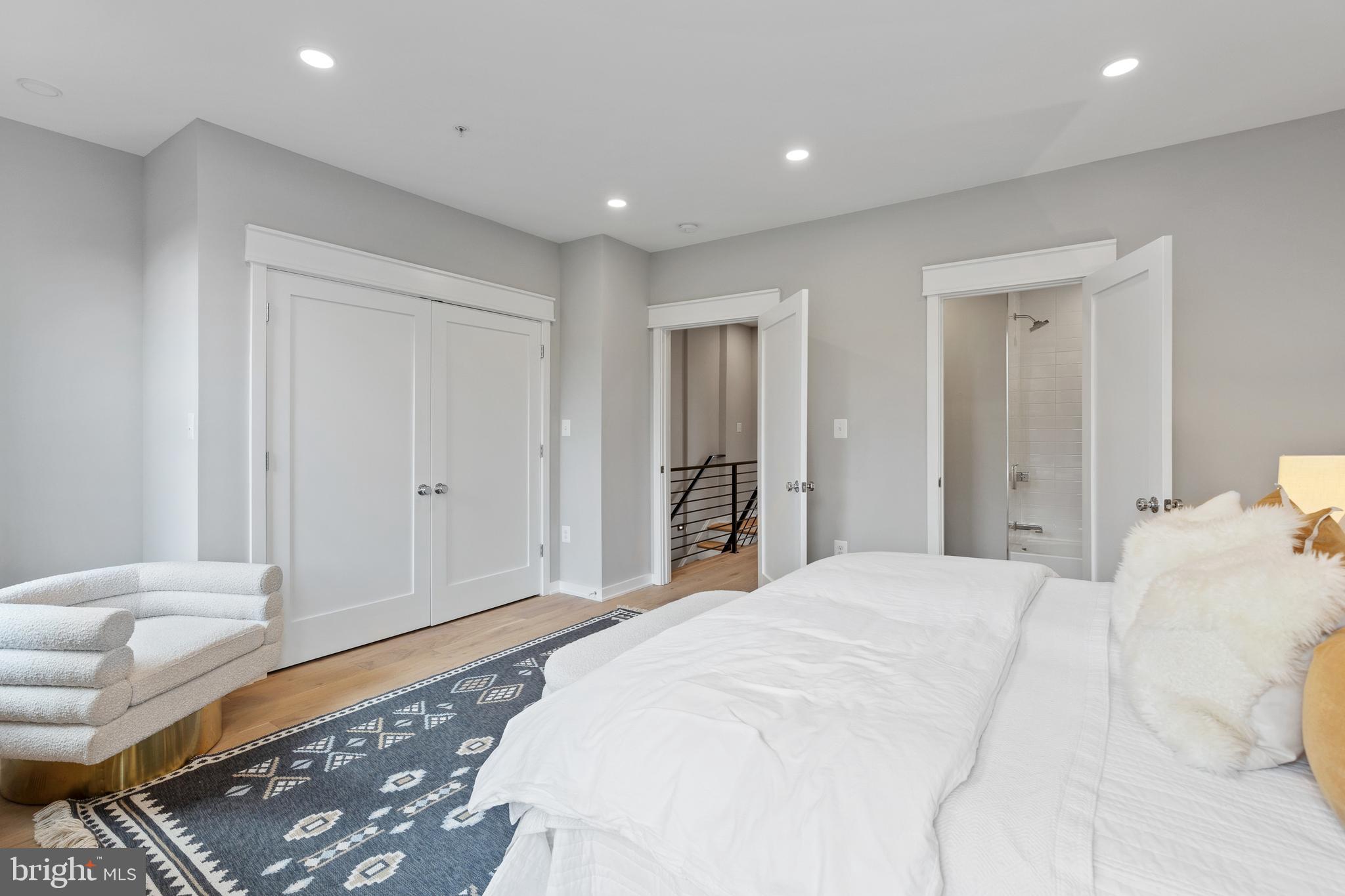 406 D Street Southeast Washington, DC 20003 - Photo 31 of 39 a spacious bedroom with a bed and a lamp