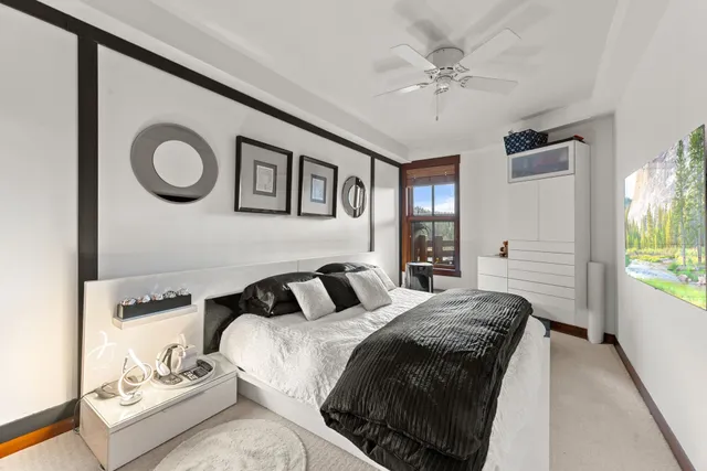 a bedroom with a bed and a chandelier