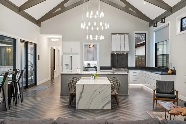 a large kitchen with a table and chairs