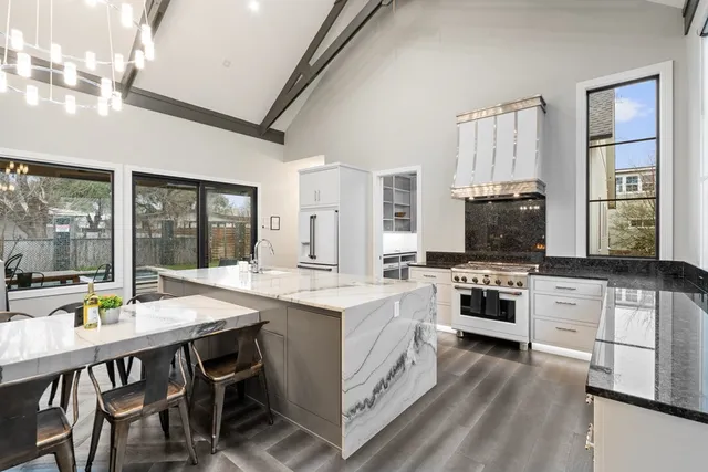 a kitchen with stainless steel appliances granite countertop a stove and cabinets