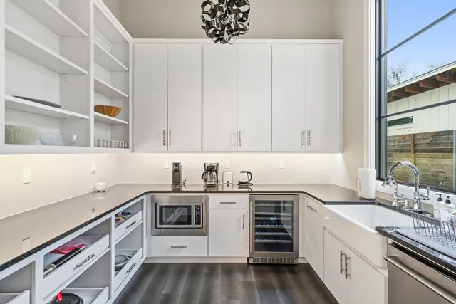a kitchen with stainless steel appliances a sink stove and cabinets