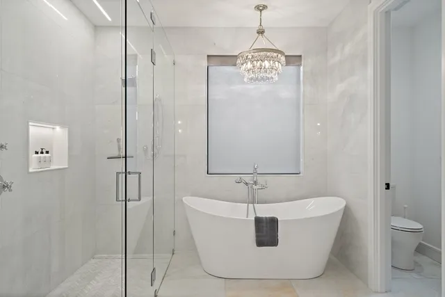 a white bath tub sitting next to a bathroom sink