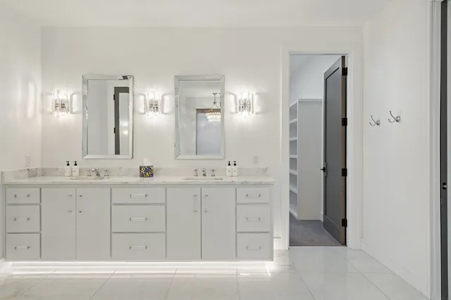 a bathroom with double vanity sink and a mirror