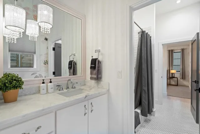 a en suite bathroom with a sink double vanity and a mirror
