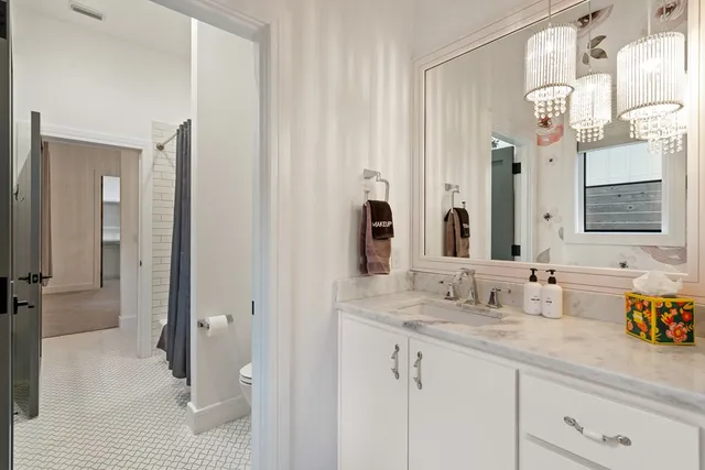 a bathroom with a double vanity sink and a mirror