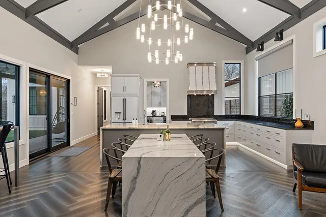 a kitchen with a table chairs refrigerator and microwave