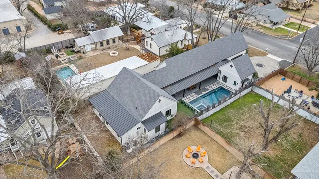 an aerial view of a house with a garden and trees