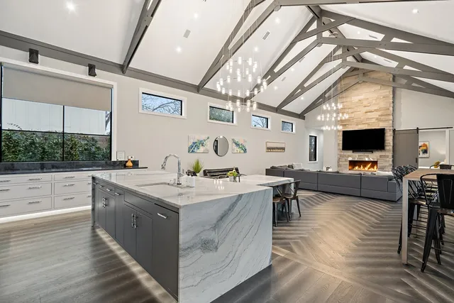 a open kitchen with stainless steel appliances granite countertop a lot of counter space and a wooden floors