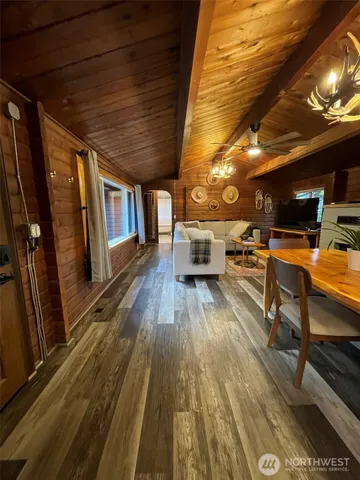 a kitchen with granite countertop a refrigerator a sink and wooden cabinets