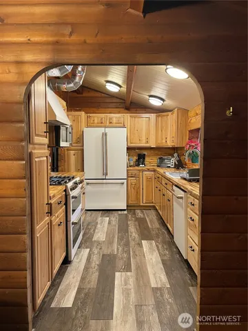 a close view of stove with wooden cabinets