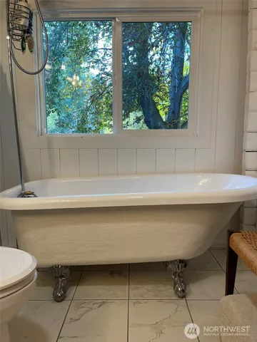 a room with water heater and a wooden floor