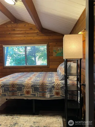 a bedroom with a bed and a mirror