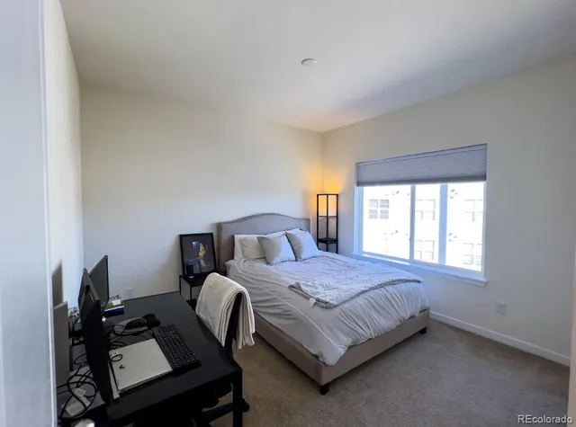 a bedroom with a bed chair and window