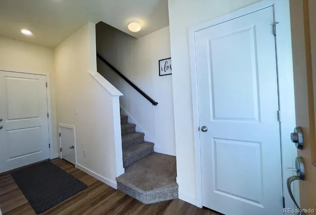 a view of entryway with wooden floor and stairs