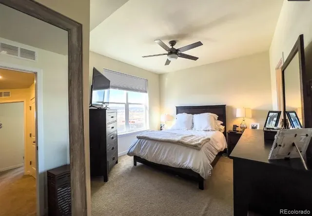 a bedroom with a bed a dresser and a large mirror