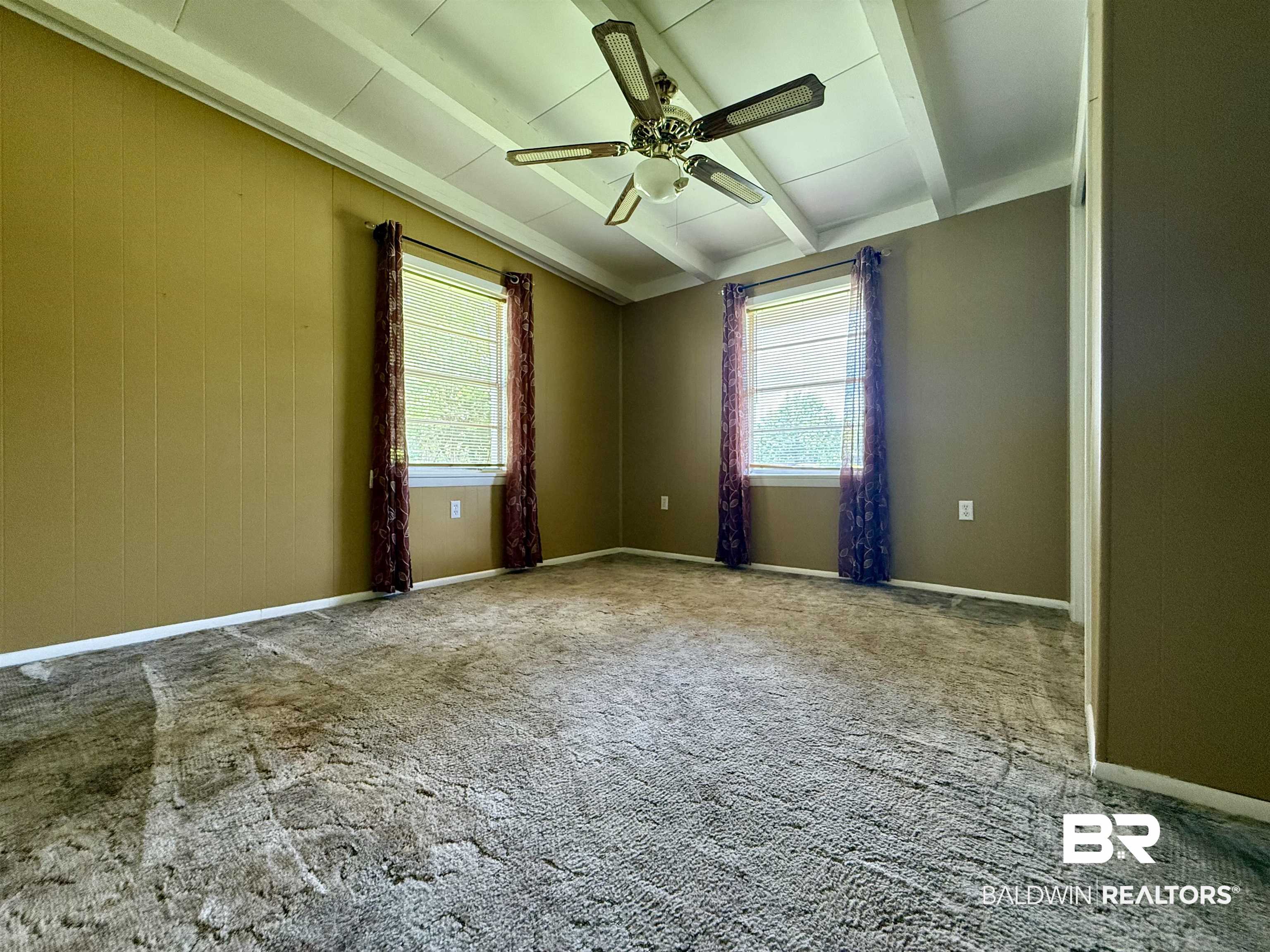 103 Kimberly Street Brewton, AL 36426 - Photo 9 of 18 Empty room with beam ceiling, ceiling fan, and carpet flooring