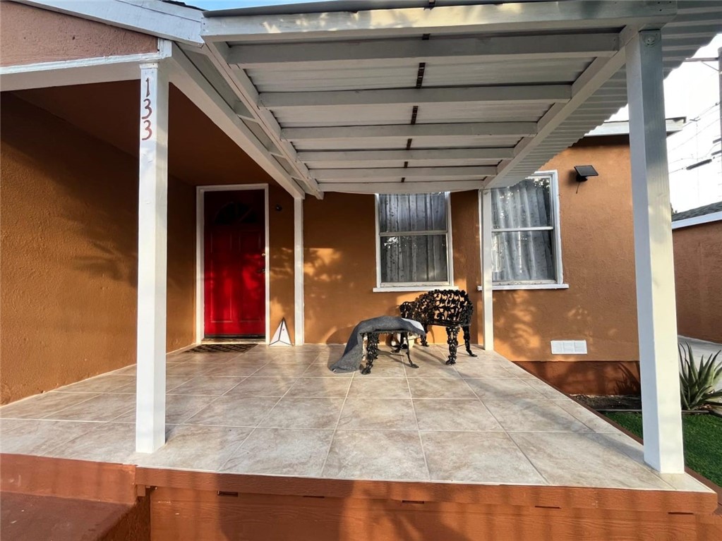 2102 East Lucien Street Compton, CA 90222 - Photo 10 of 10 a view of a porch with a table and chairs and potted plants