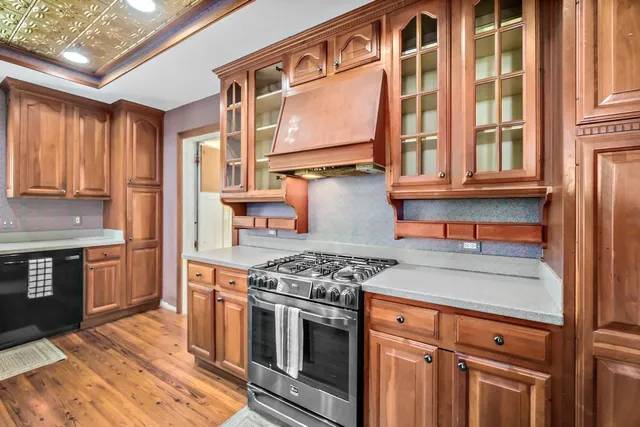 a kitchen with stainless steel appliances granite countertop a stove and a refrigerator
