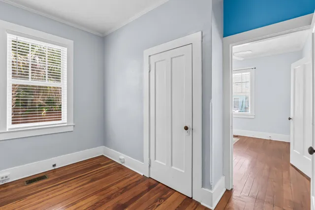 a view of a room with wooden floor and window