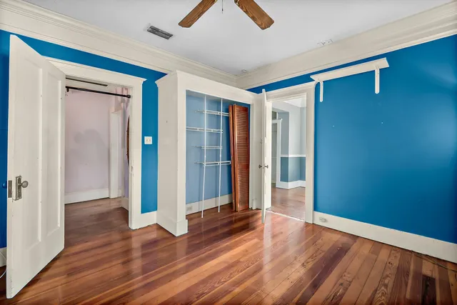 a view of empty room with wooden floor