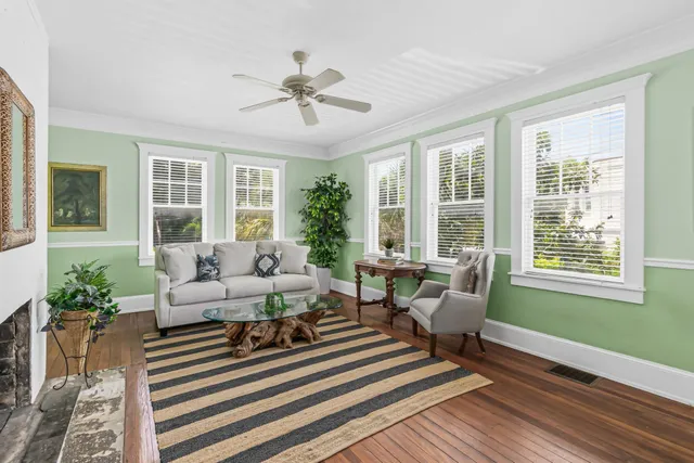 a living room with furniture and wooden floor