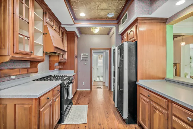 a kitchen with stainless steel appliances granite countertop a stove and a refrigerator