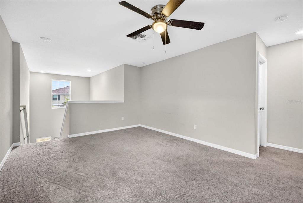 9616 Lemon Drop Loop Sun City Center, FL 33573 - Photo 29 of 53 an empty room with closet and windows