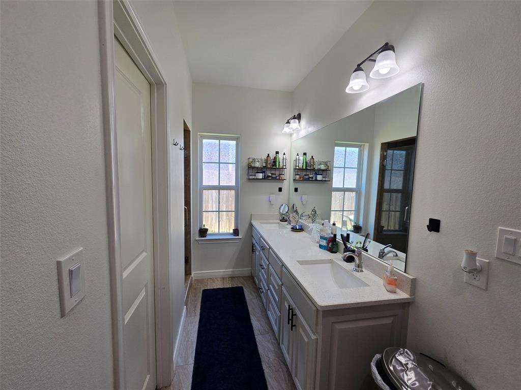 109 Baker Street Mount Vernon, TX 75457 - Photo 12 of 23 a bathroom with a sink and a mirror