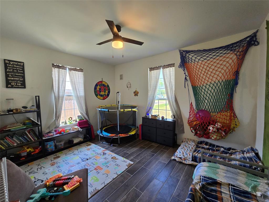 109 Baker Street Mount Vernon, TX 75457 - Photo 18 of 23 a living room with furniture a window and gym equipment