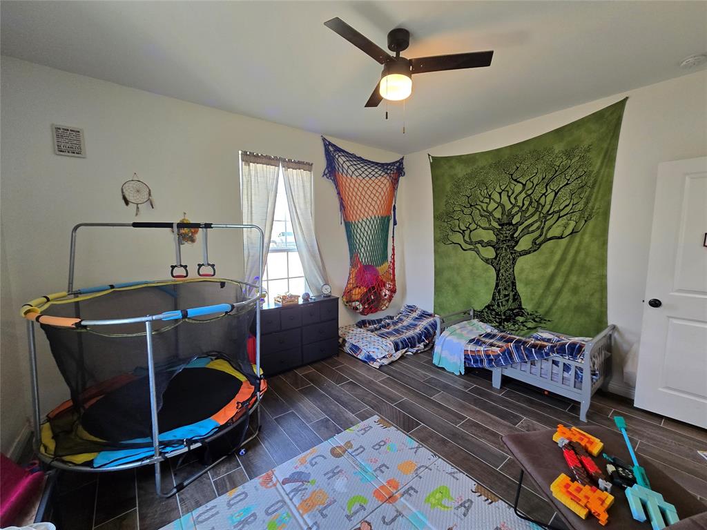 109 Baker Street Mount Vernon, TX 75457 - Photo 19 of 23 a living room with furniture and a flat screen tv