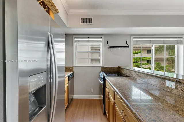 a kitchen with a refrigerator and a sink