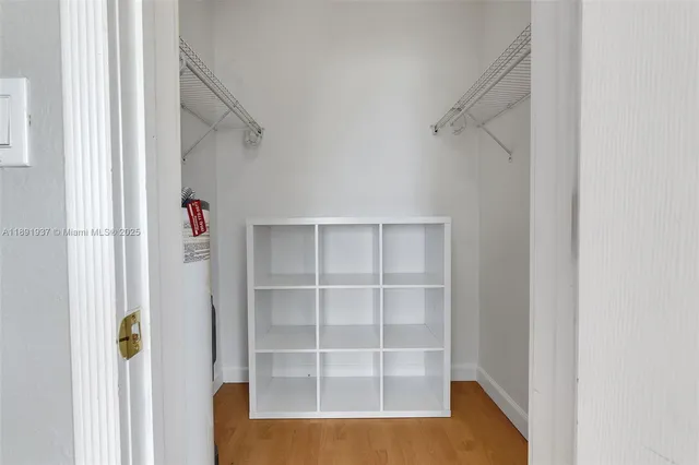 a view of walk in closet with empty racks