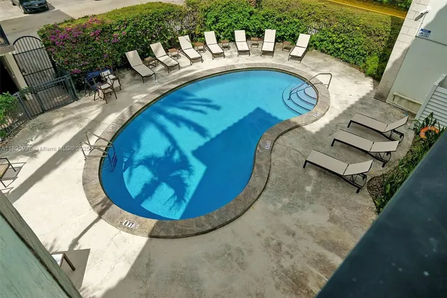 a front view of residential houses with outdoor seating