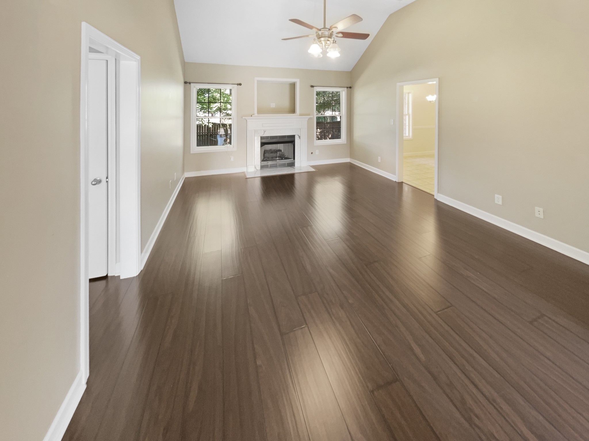 802 Riata Court Smyrna, TN 37167 - Photo 2 of 16 an empty room with wooden floor fireplace and windows