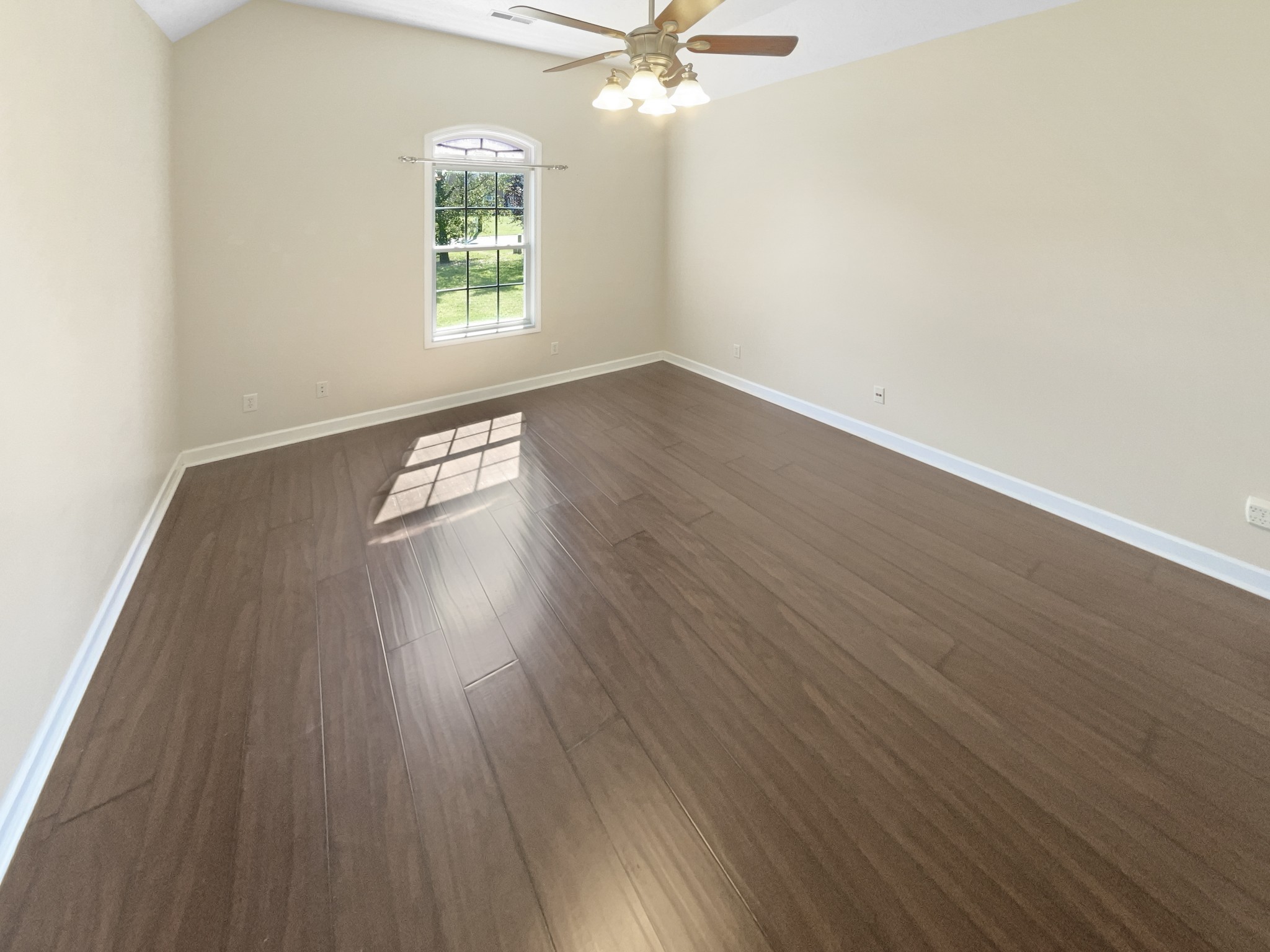 802 Riata Court Smyrna, TN 37167 - Photo 6 of 16 an empty room with wooden floor chandelier fan and windows