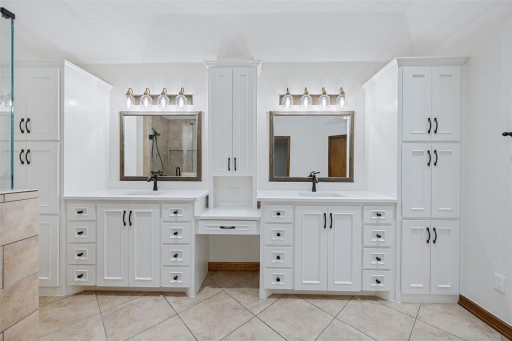 1607 North Main Street Euless, TX 76039 - Photo 10 of 39 a bathroom with a sink vanity and mirror