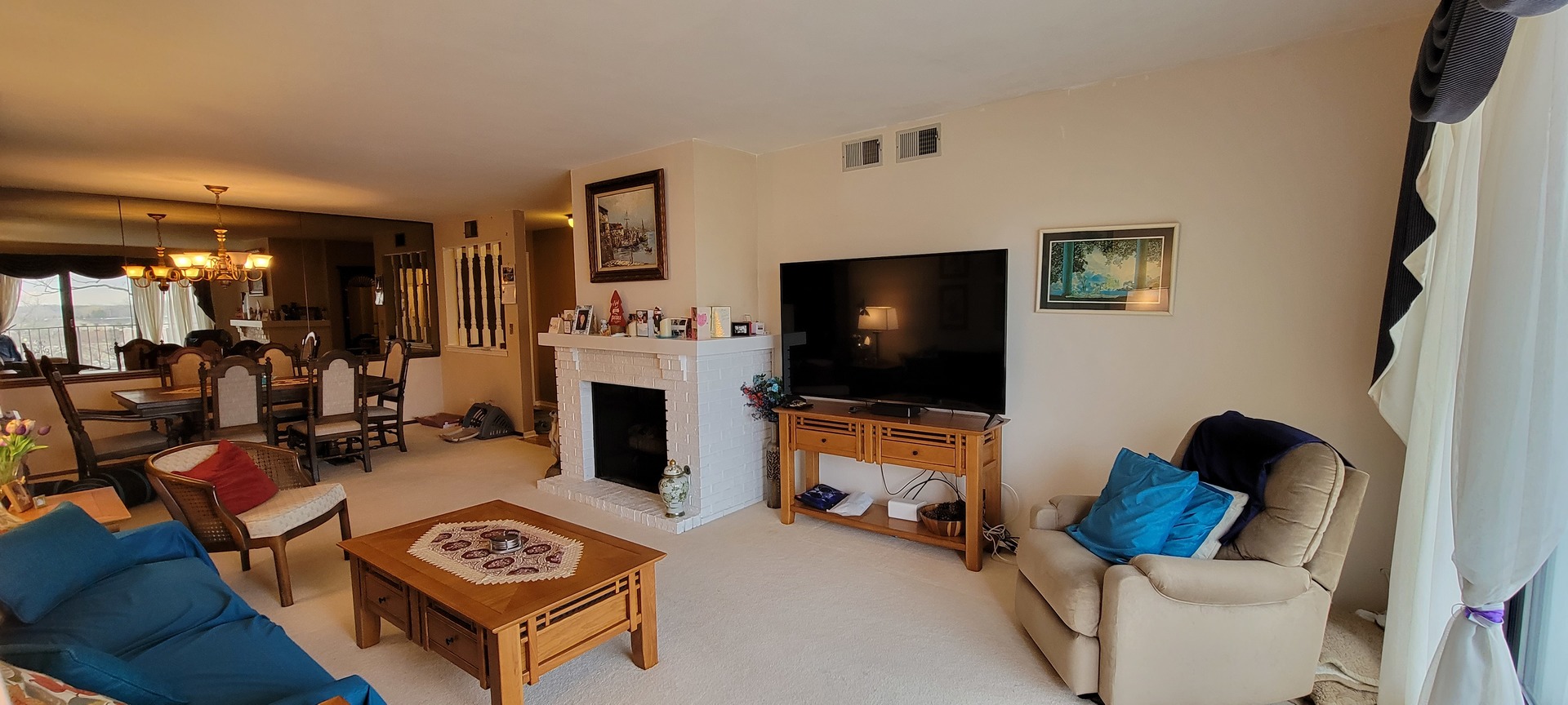 1-s150 Spring Road, Unit 5C Oak Brook, IL 60181 - Photo 4 of 12 a living room with furniture and a flat screen tv