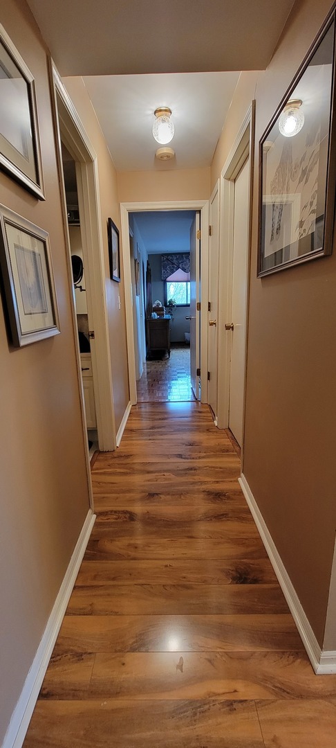 1-s150 Spring Road, Unit 5C Oak Brook, IL 60181 - Photo 6 of 12 a view of a hallway view with wooden floor and staircase