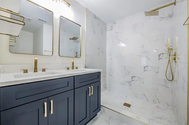 a bathroom with a shower sink and mirror