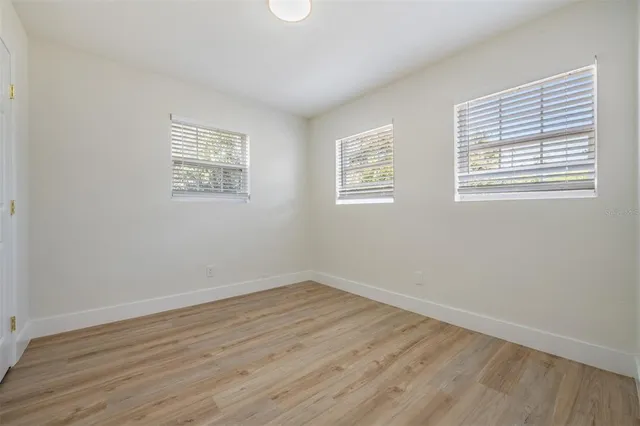 a view of a room with wooden floor and windows