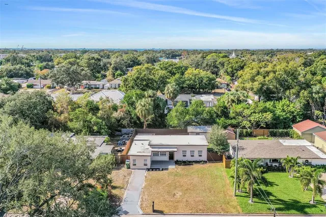 an aerial view of a house with big yard