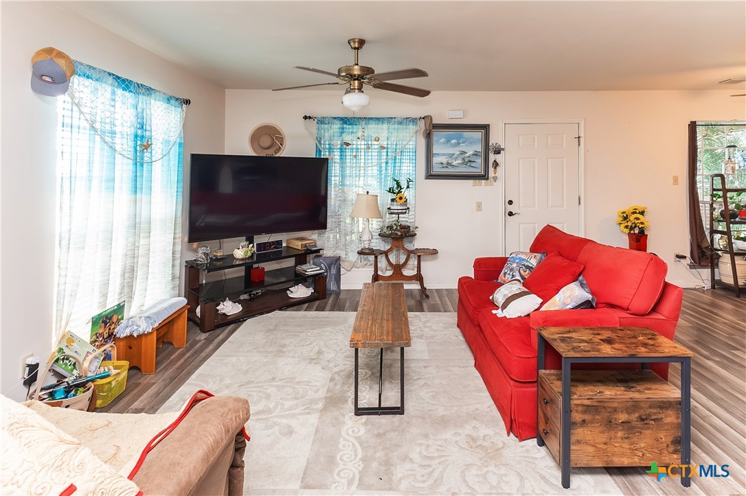 802 Bay Street Austwell, TX 77950 - Photo 6 of 27 a living room with furniture a flat screen tv and a large window