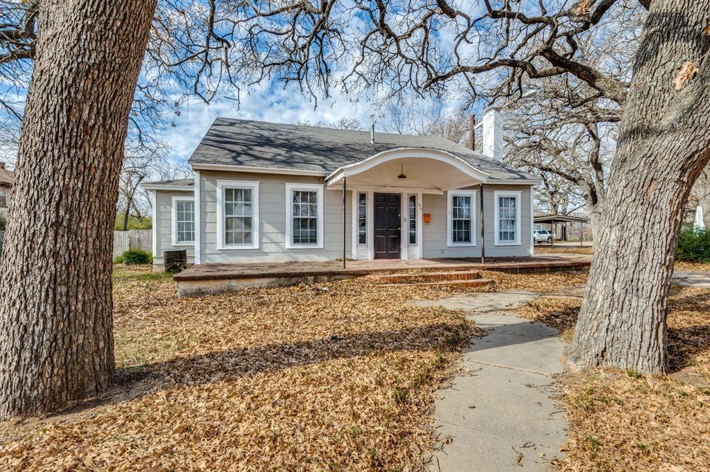 front view of a house with a large tree