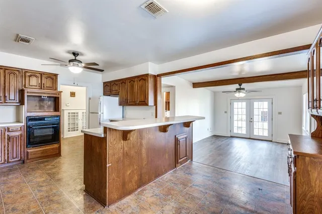 a view of kitchen with cabinets and wooden floor