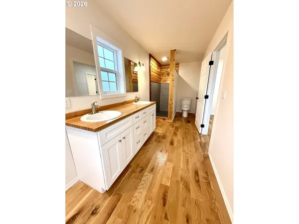 a large room with a sink and a wooden floor