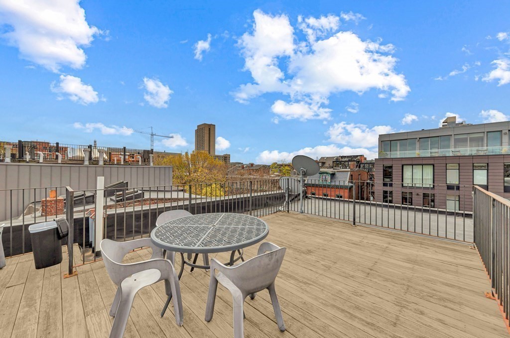 10 East Springfield Street, Unit 3 Boston, MA 02118 - Photo 25 of 26 a balcony with wooden floor table and chairs