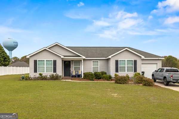 a front view of house with yard and green space