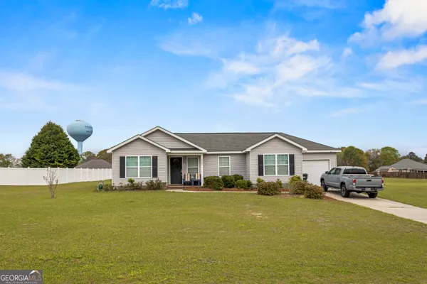 a front view of a house with a garden