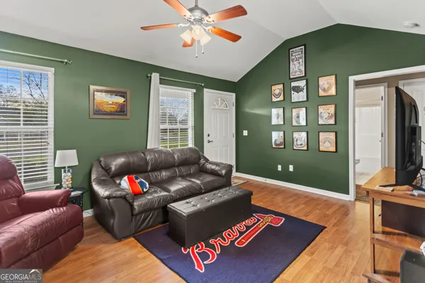 a living room with furniture and a flat screen tv