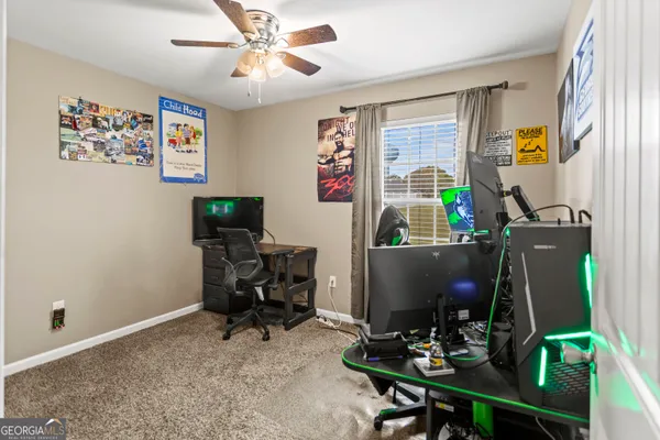 a view of a workspace with furniture and a window